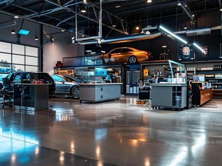 Modern car service garage interior with cars, workstations, and overhead lift.