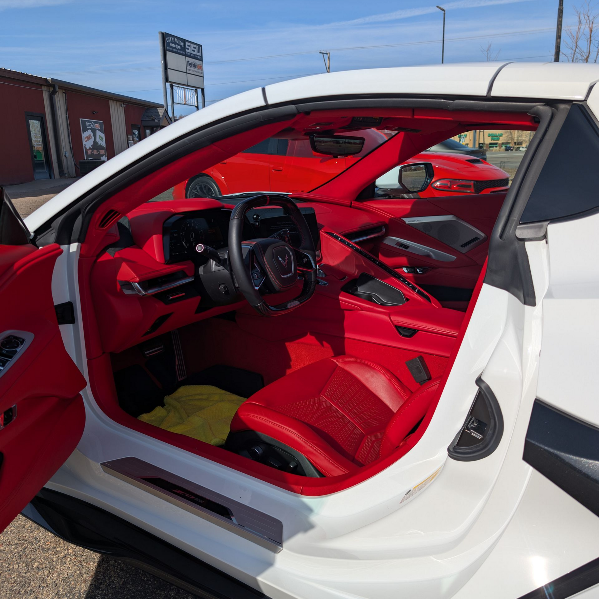 Tan leather interior of a BMW, including steering wheel, dashboard, and seats.