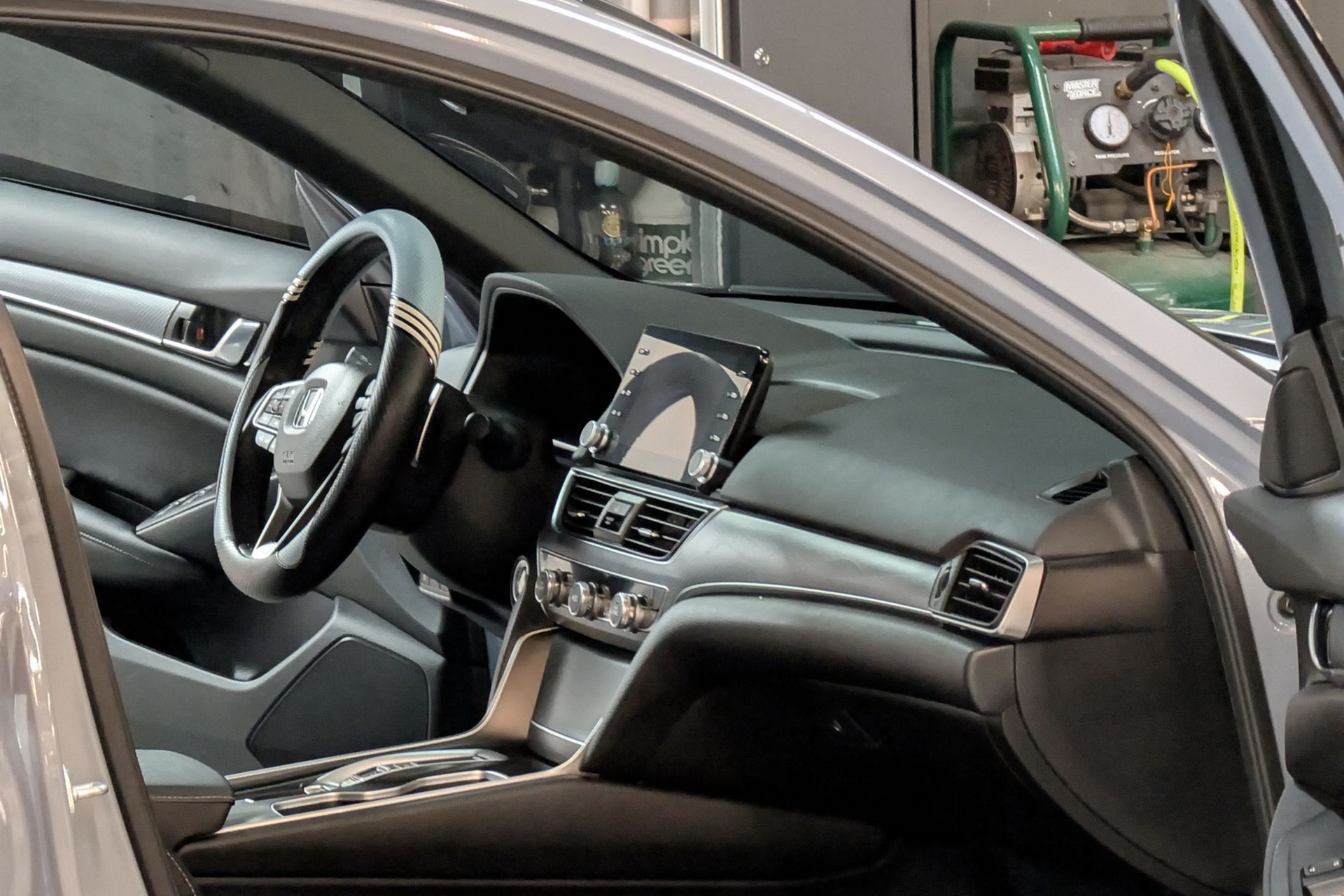 Car dashboard cleaning with black gloves