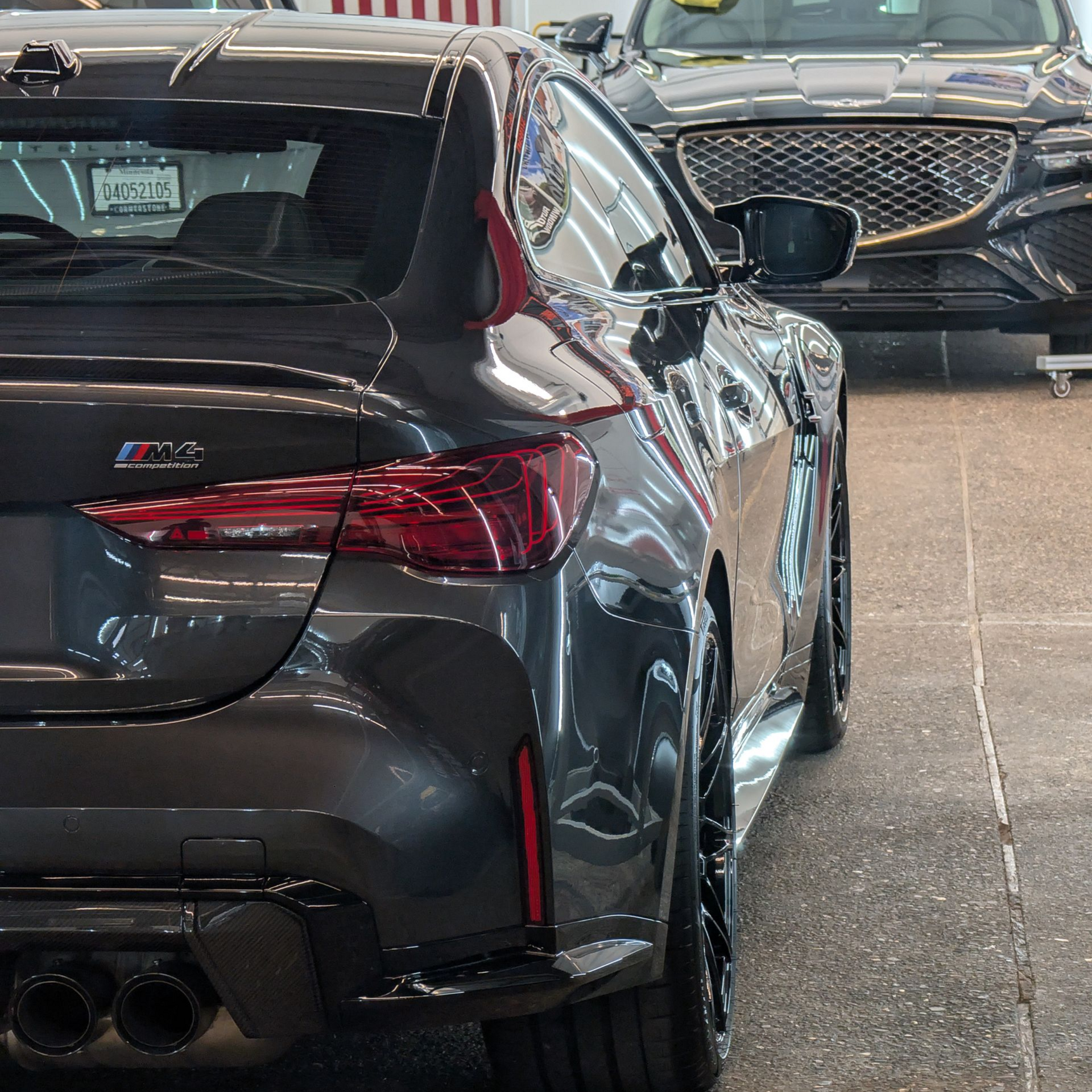 Silver BMW M5 sedan parked inside a bright, clean garage.