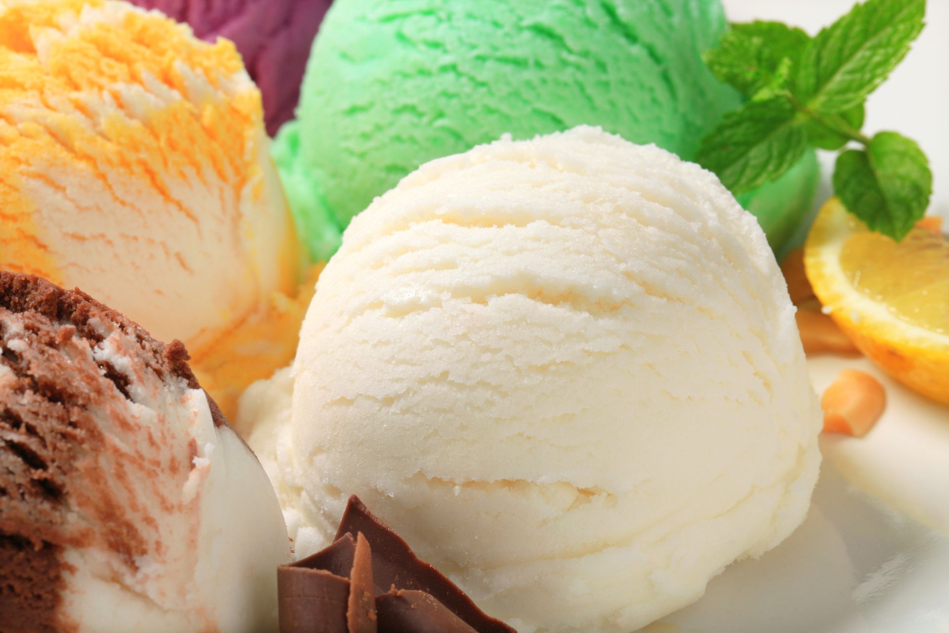 There are many different flavors of ice cream on a plate.