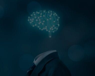 A suit with a brain-shaped circuit board replacing the head, hovering against a dark blue background.