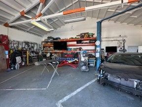 Car Is Sitting on A Lift in A Garage — Santa Cruz, CA — Santa Cruz All Star Body Works