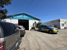 Row of Cars Are Parked in Front of A Building — Santa Cruz, CA — Santa Cruz All Star Body Works