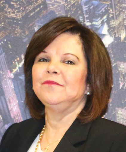 A woman in a black jacket and white shirt is smiling for the camera.