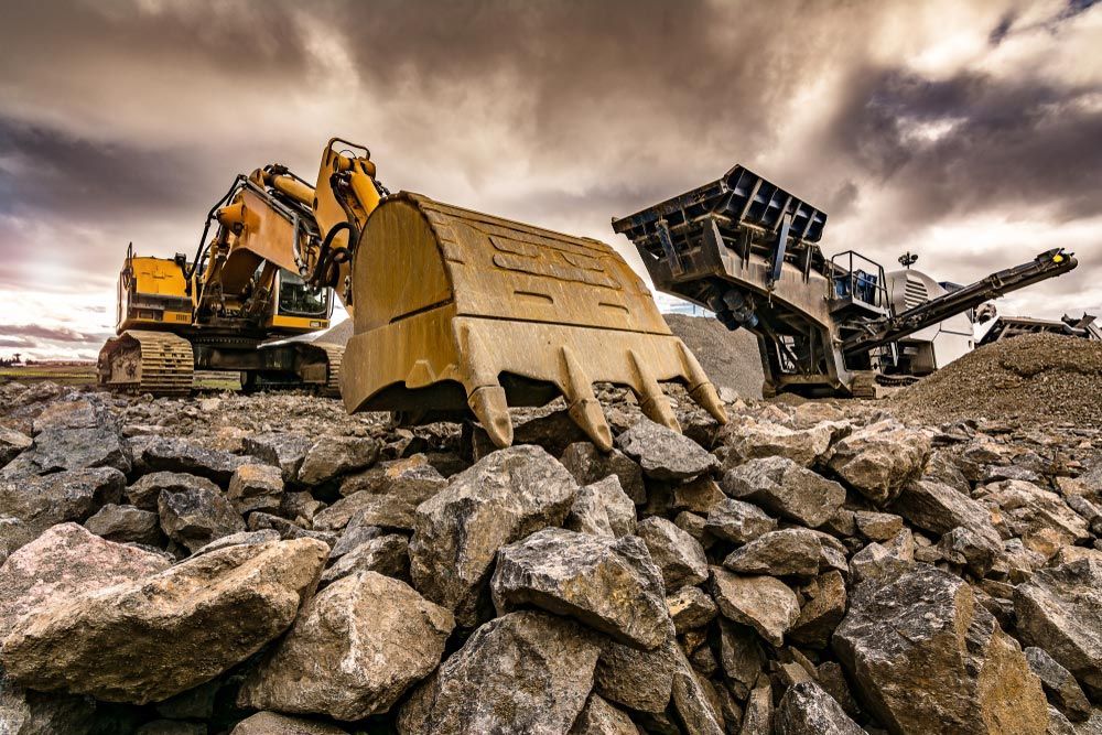 A Bulldozer and A Crusher Are Sitting on Top of A Pile of Rocks — Inline Truck and Plant in Tuggerah, NSW