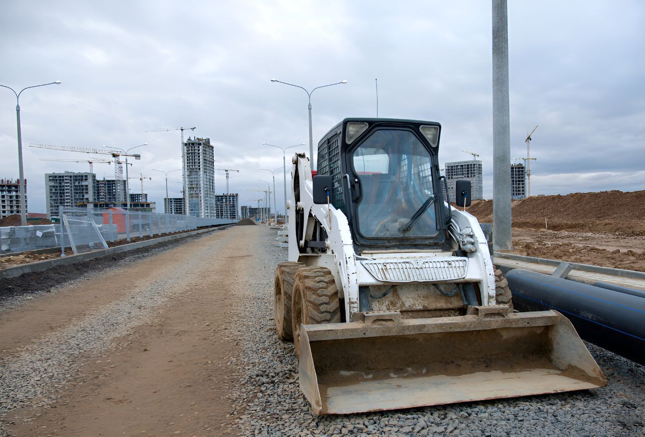 A Bulldozer is Driving Down a Dirt Road — Inline Truck and Plant in Tuggerah, NSW
