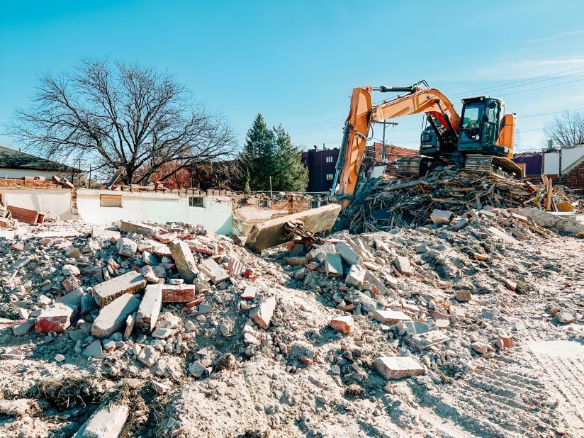A bulldozer is demolishing a building on a construction site — Inline Truck and Plant in Tuggerah, NSW