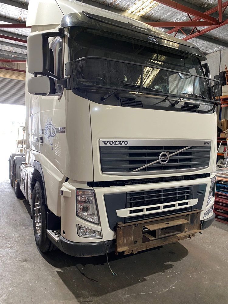 A White Volvo Semi Truck is Parked in a Garage — Inline Truck and Plant in Tuggerah, NSW