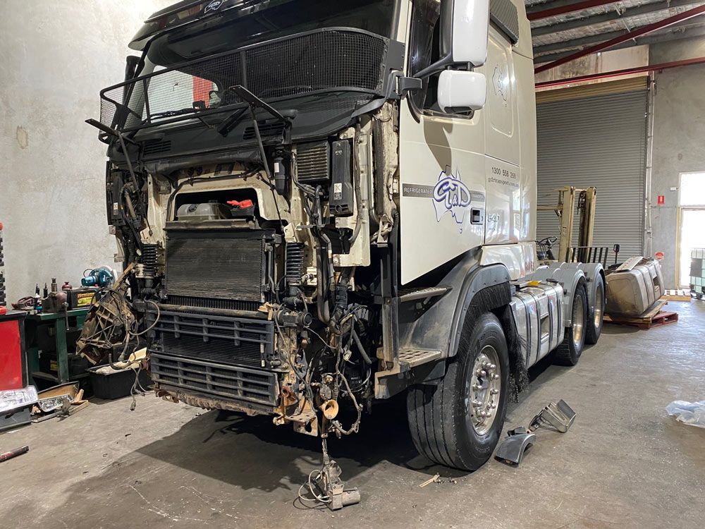 A Truck is Sitting in a Garage With Its Hood Missing — Inline Truck and Plant in Tuggerah, NSW