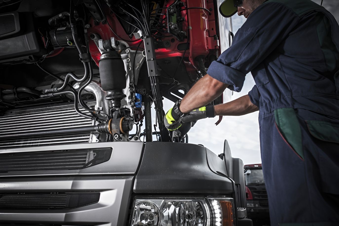 A Man is Working on the Engine of a Truck — Inline Truck and Plant in Tuggerah, NSW