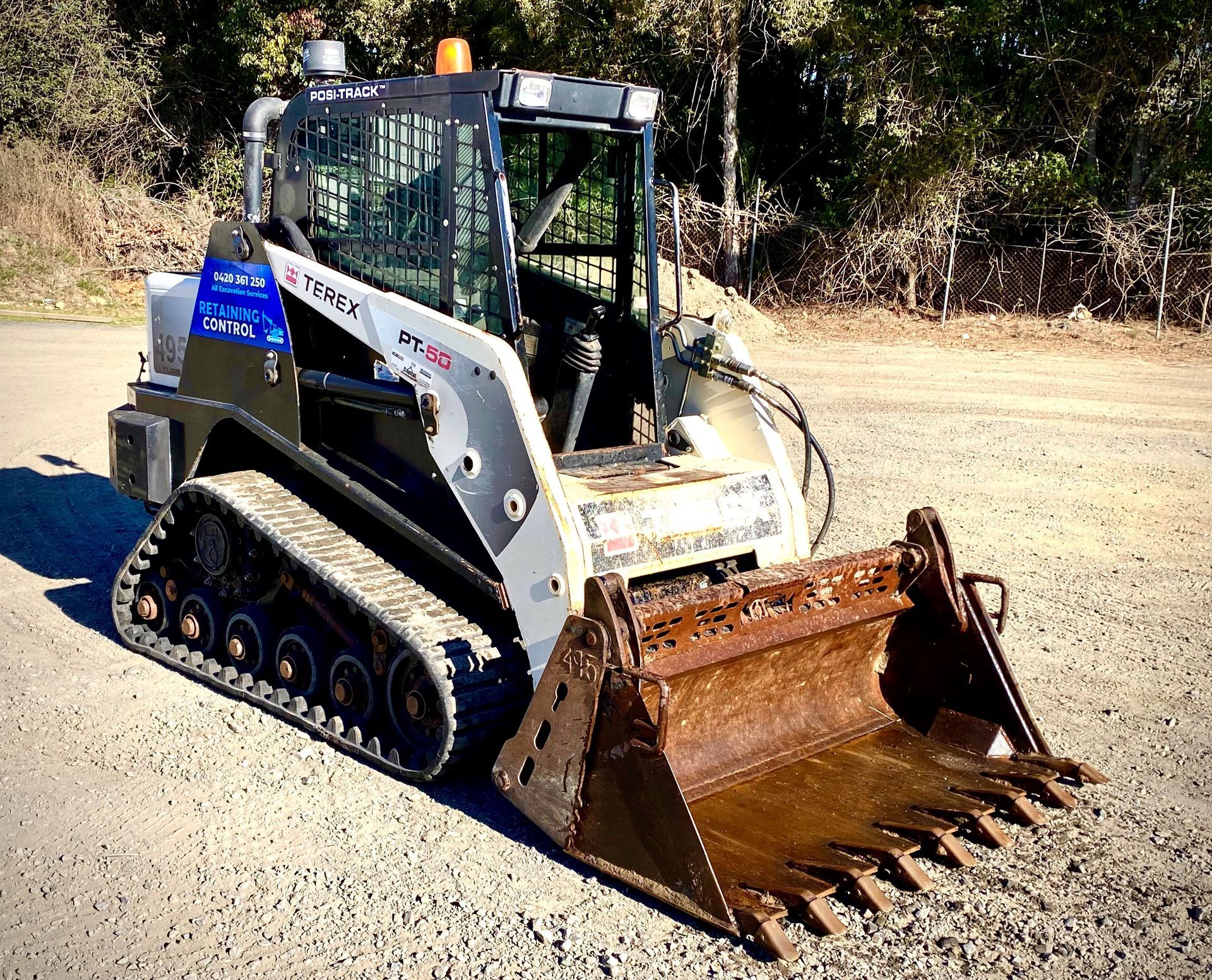 A Bulldozer With a Large Bucket is Parked on the Side of the Road — Inline Truck and Plant in Tuggerah, NSW