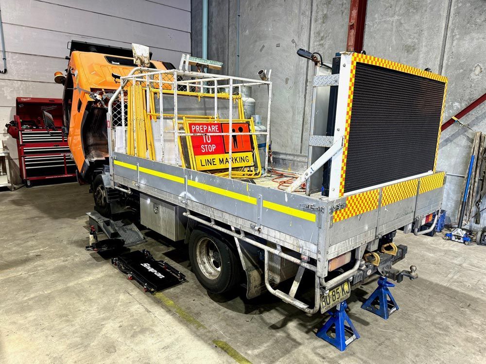 A Truck is Sitting in a Garage With Its Hood Missing — Inline Truck and Plant in Tuggerah, NSW