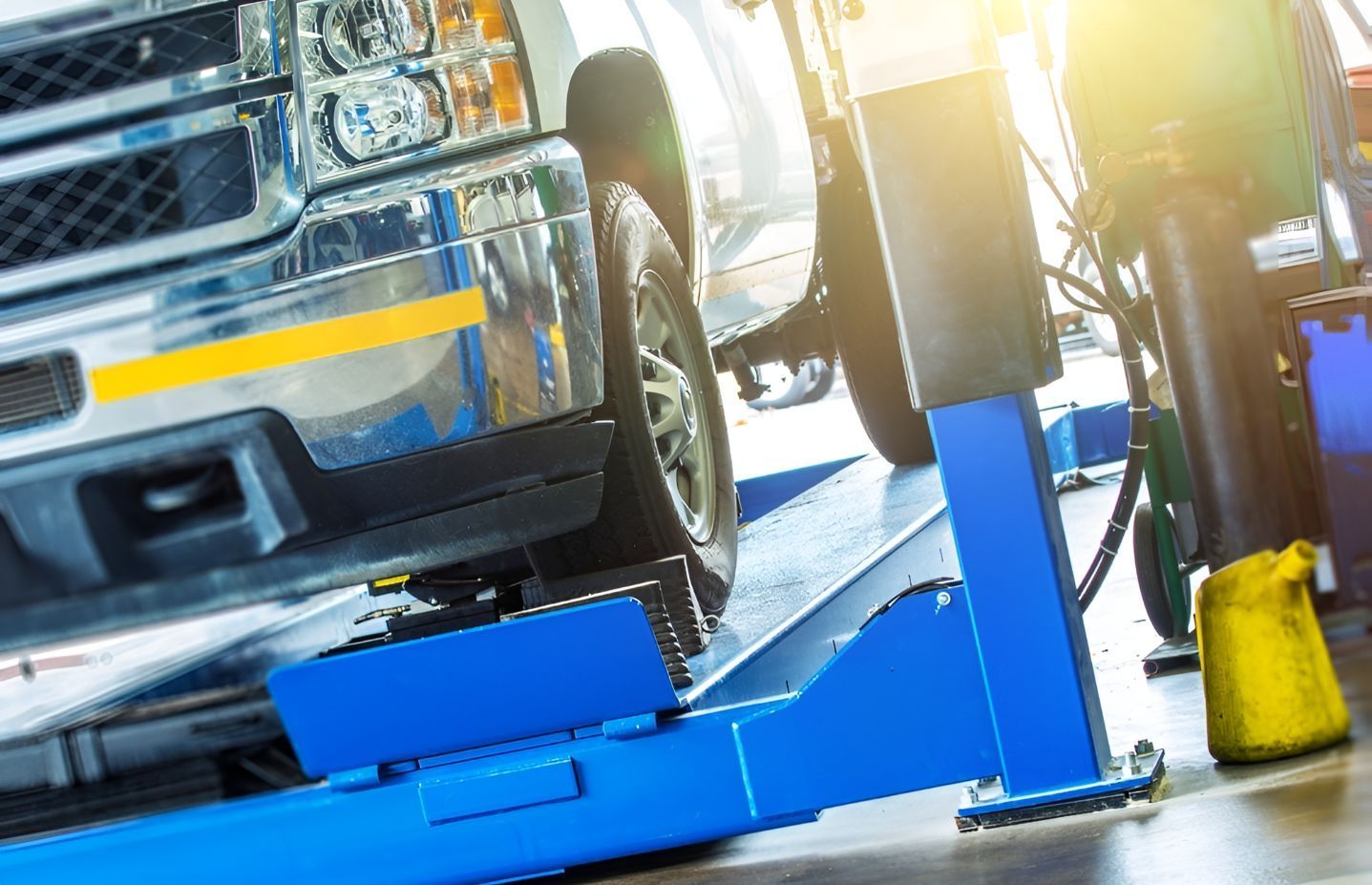 A Truck is Sitting on a Lift in a Garage — Inline Truck and Plant in Tuggerah, NSW