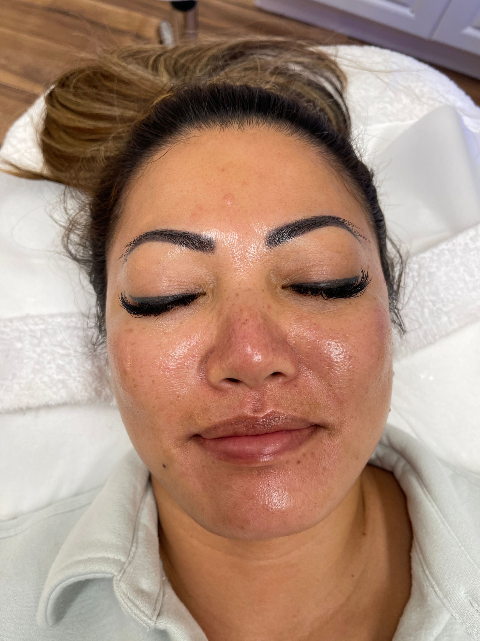 a close up of a woman 's face with her eyes closed