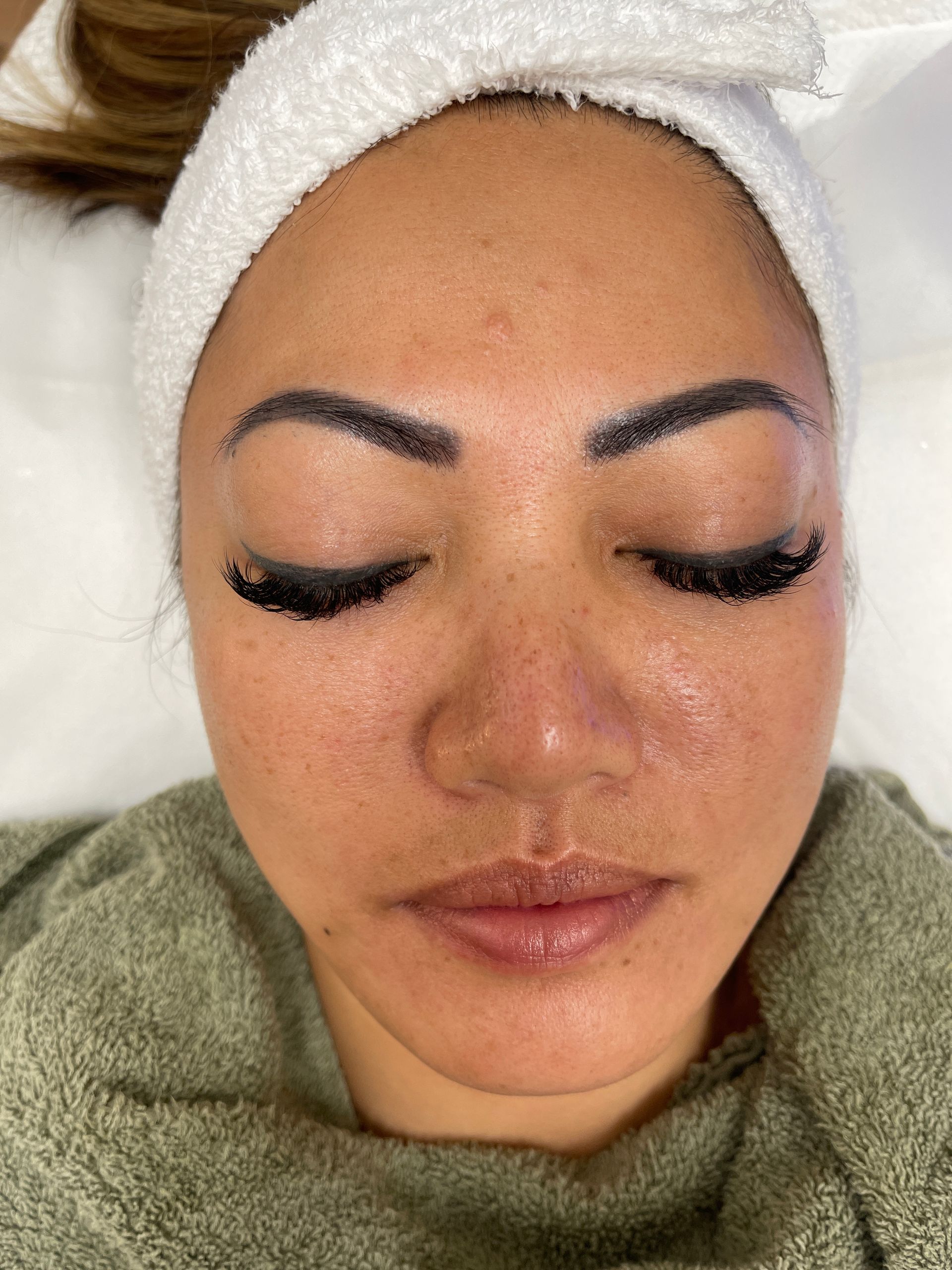 a woman with a headband on her head has her eyes closed