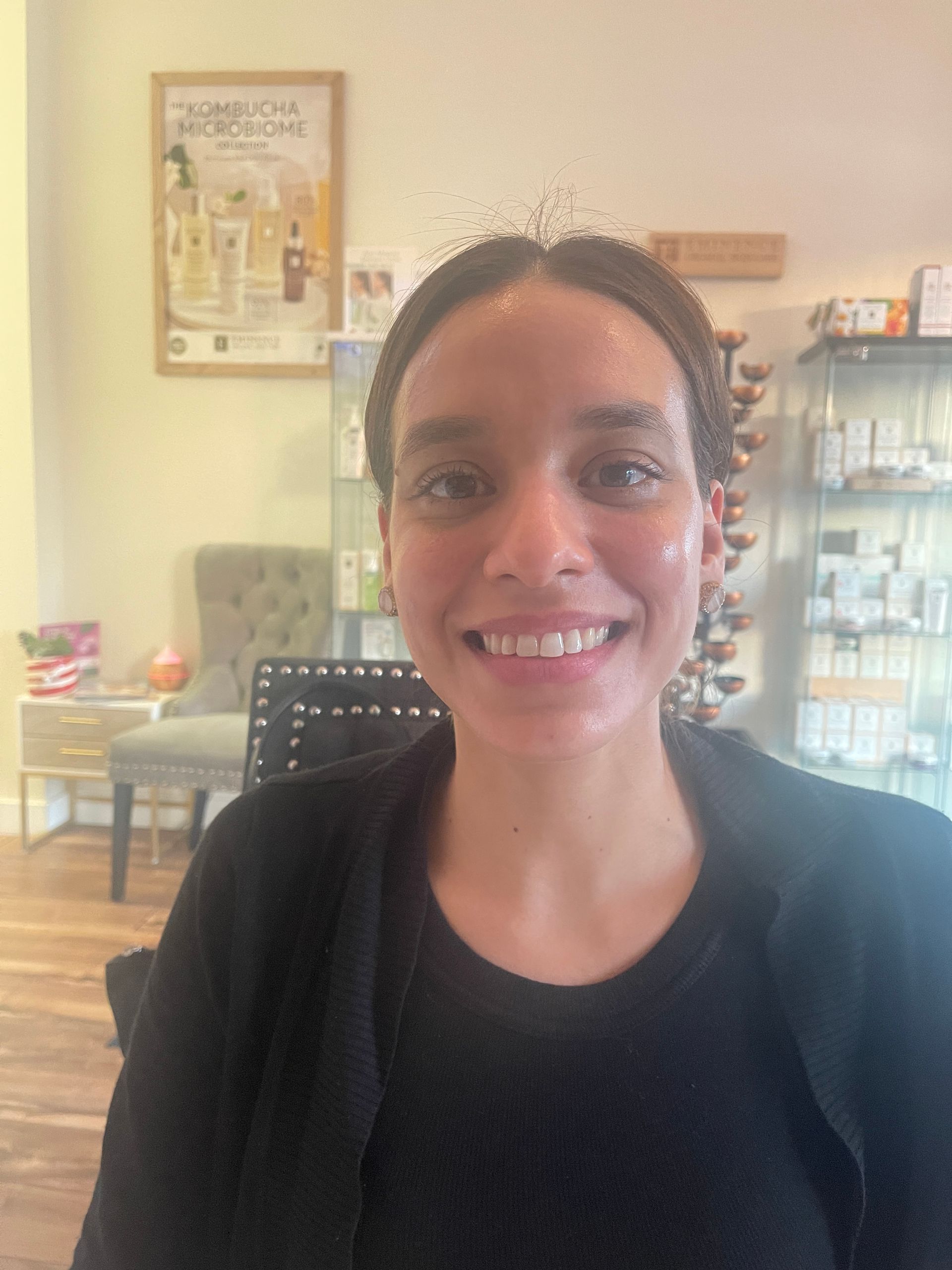 a woman is smiling in front of a kombucha microbiome poster