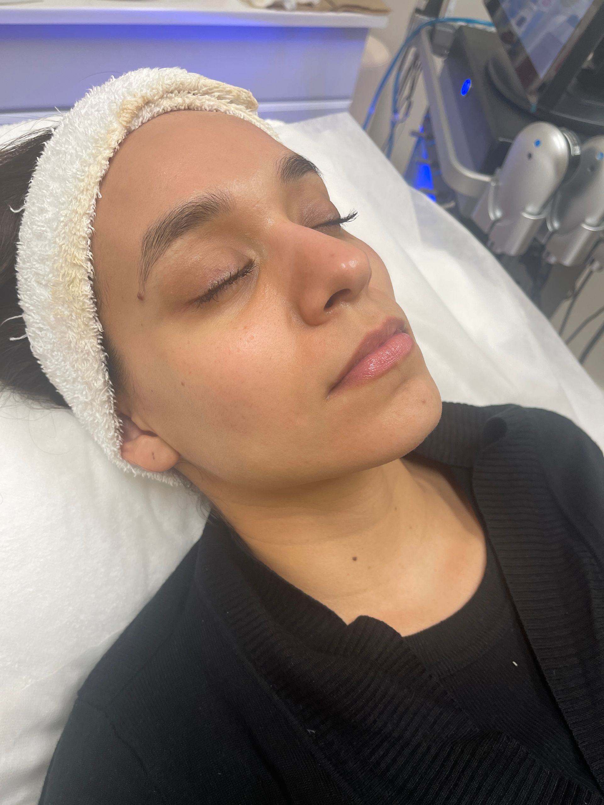 a woman is laying on a bed with her eyes closed