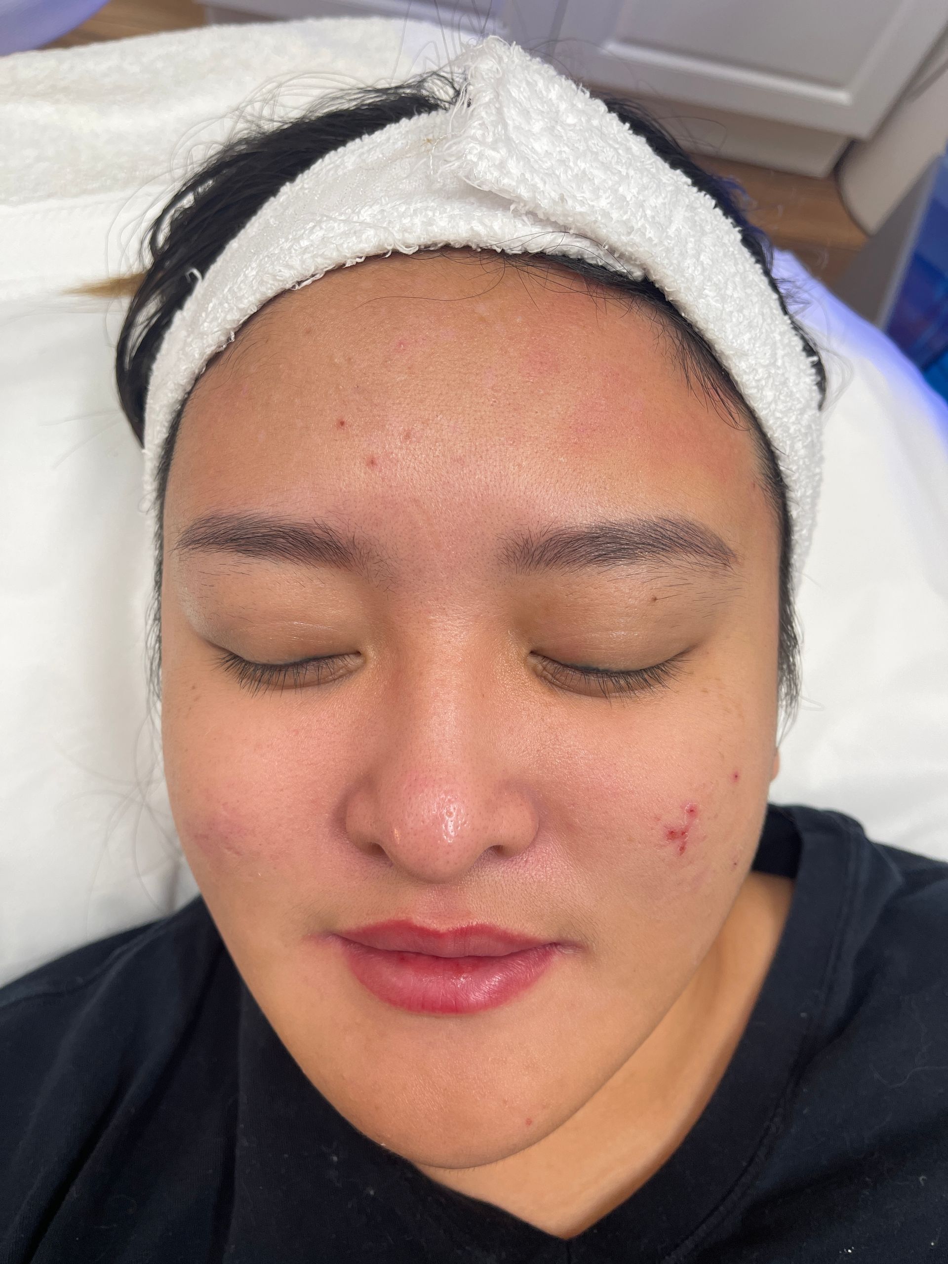 a woman with a headband on her head has her eyes closed