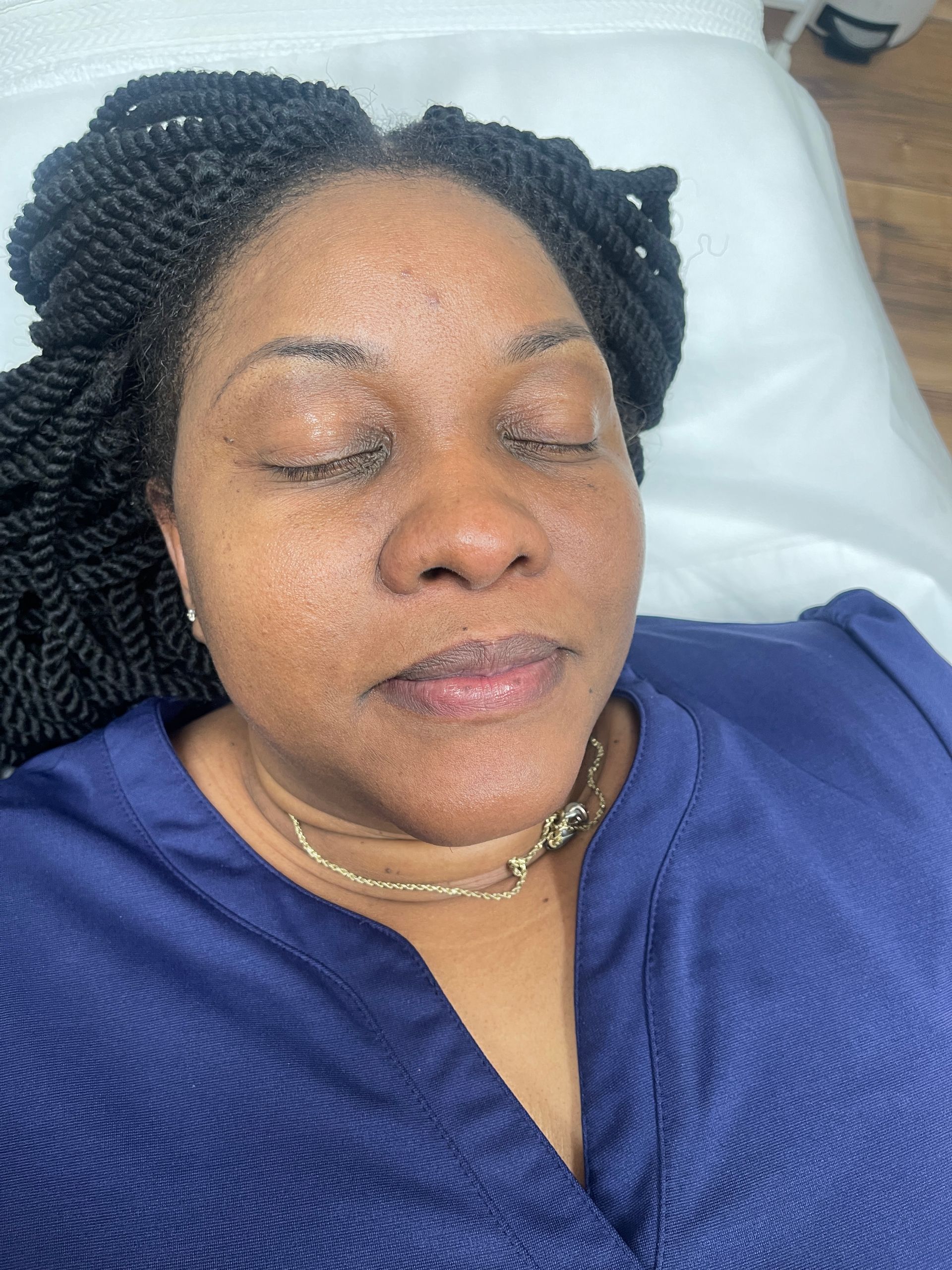 a woman with her eyes closed is wearing a blue shirt