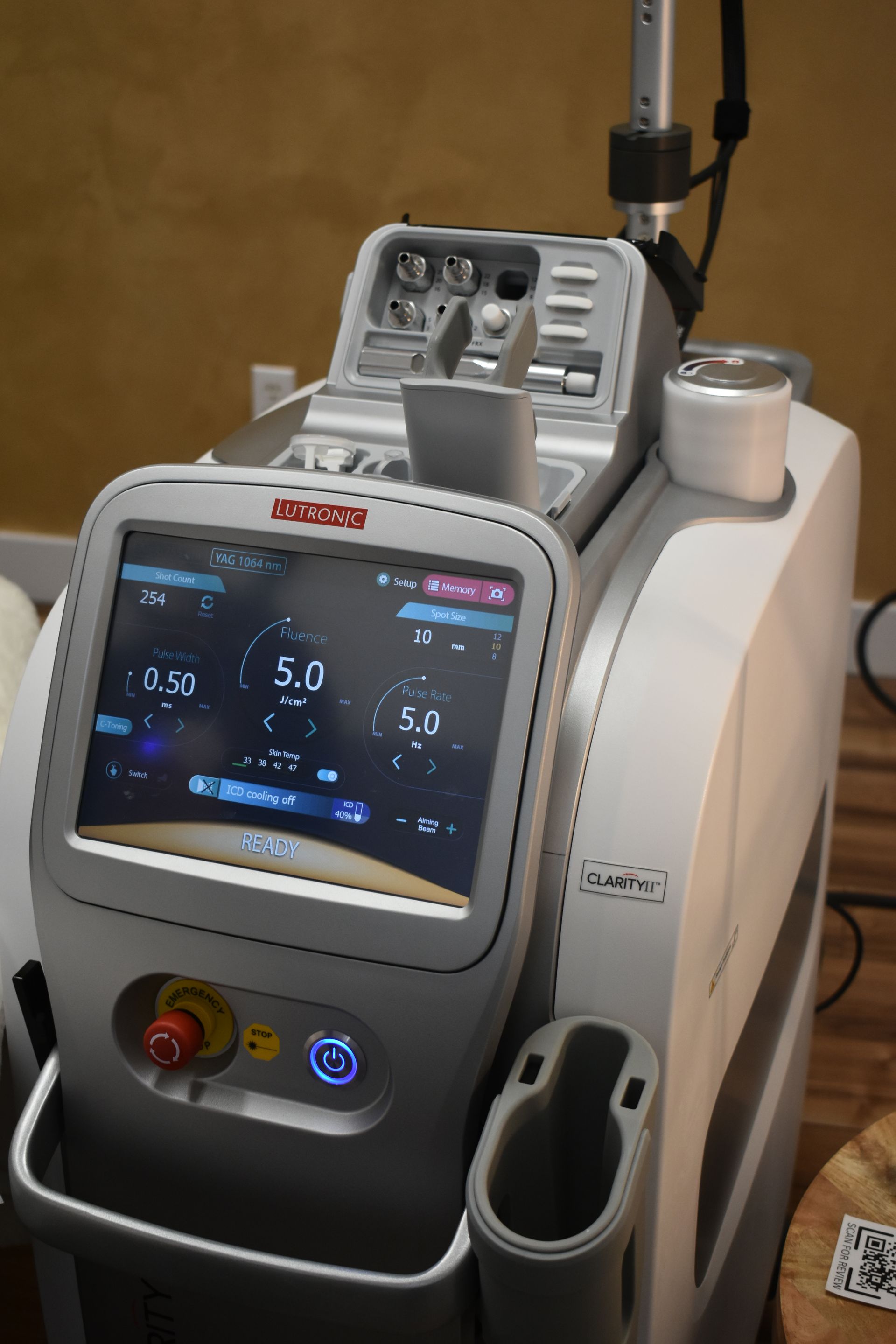 A woman is getting an ultrasound treatment on her face