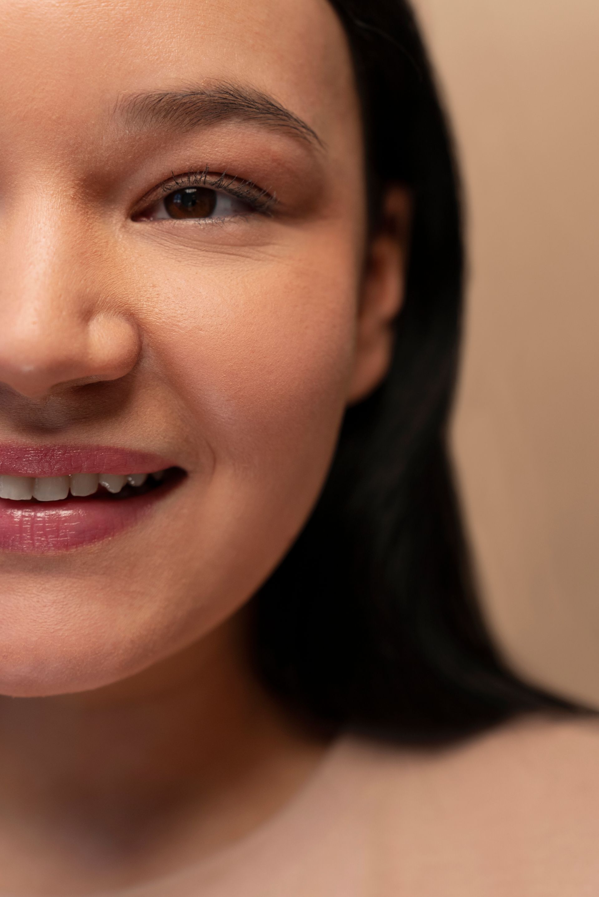 A close up of a woman 's face with a smile on her face.