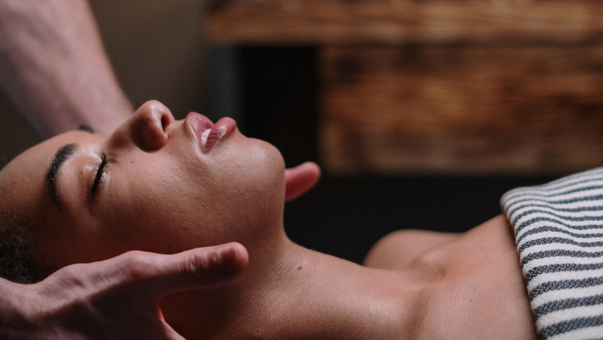 A woman is getting a head massage at a spa.