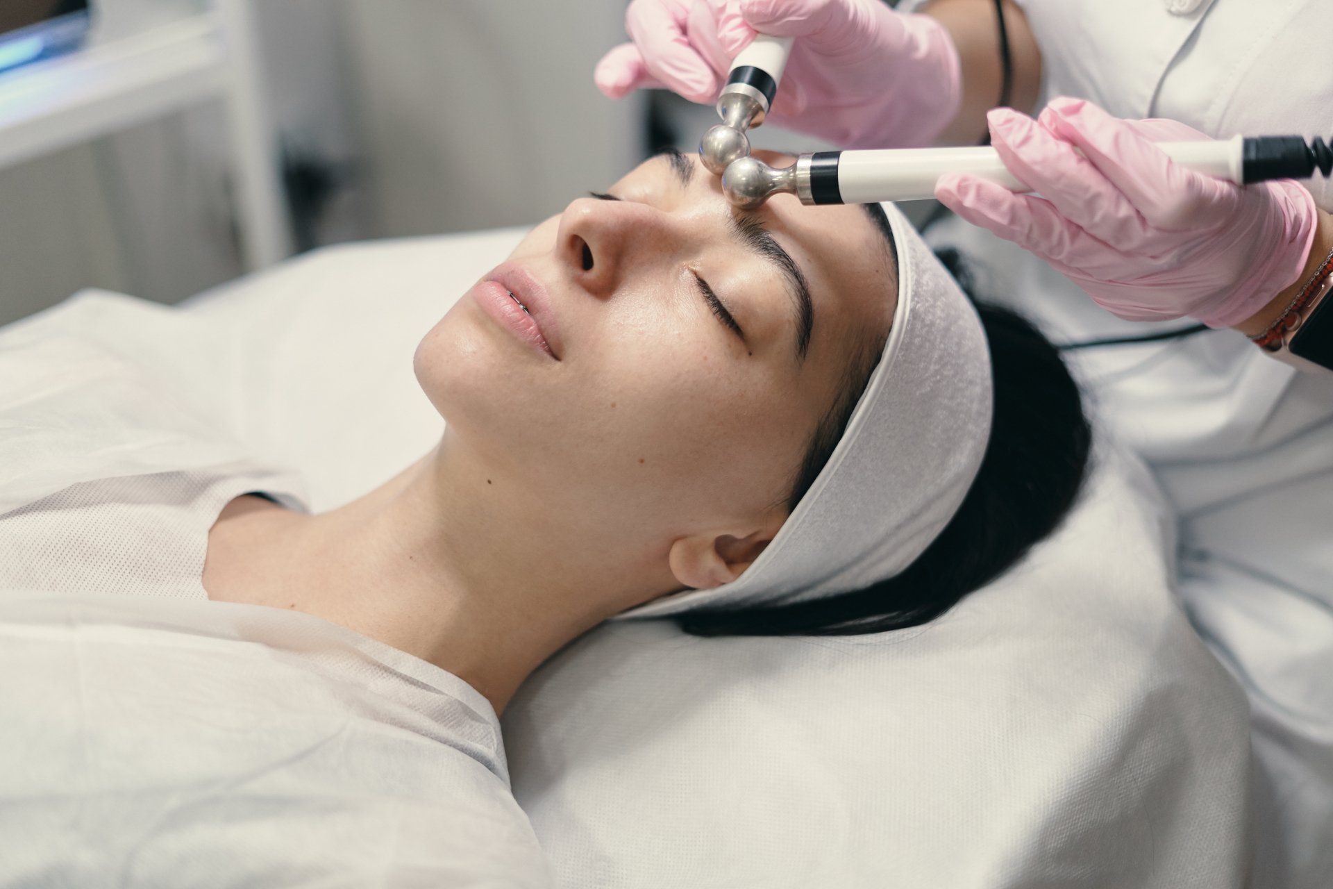 A woman is getting a facial treatment at a beauty salon.