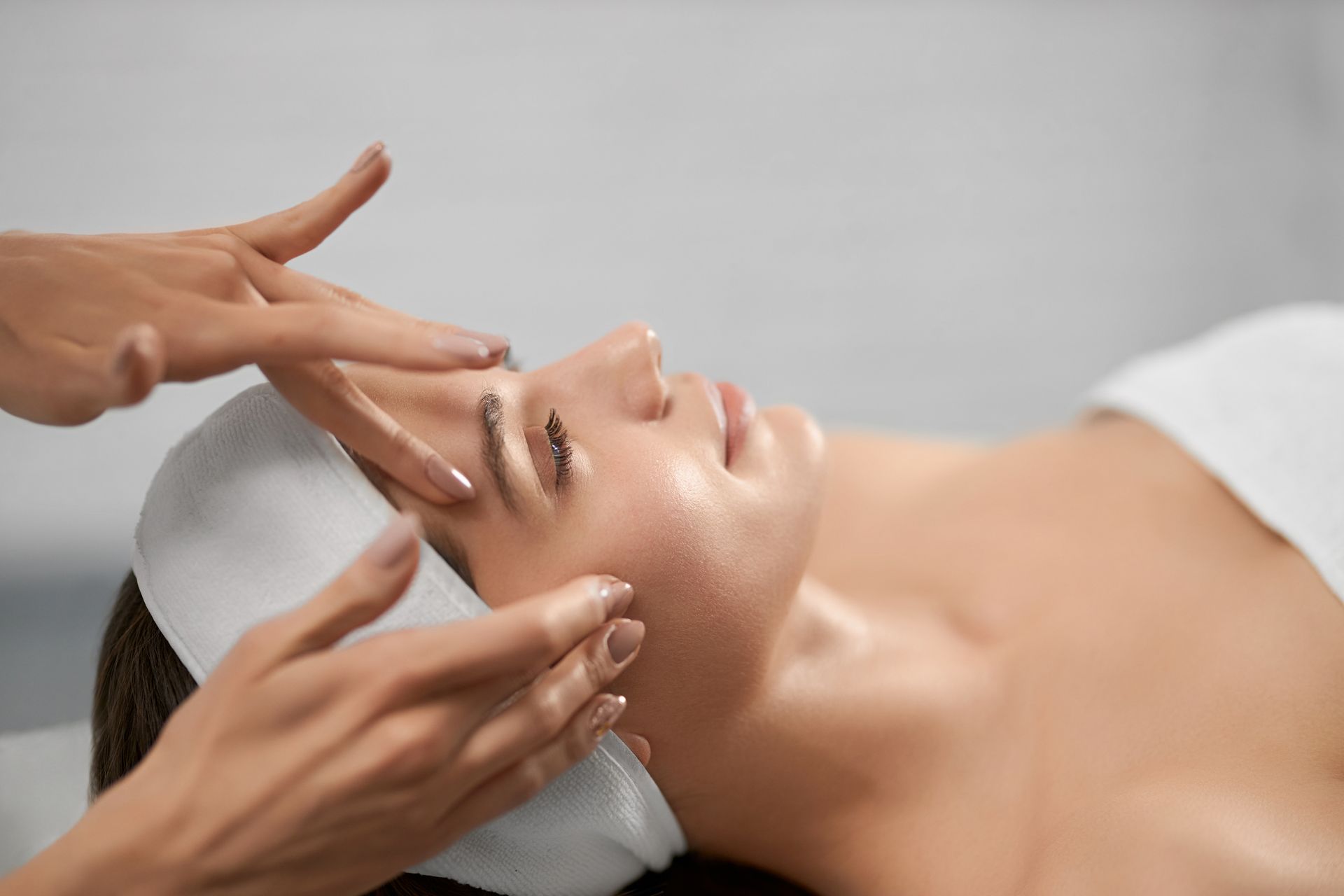 A woman is getting a facial treatment at a spa.