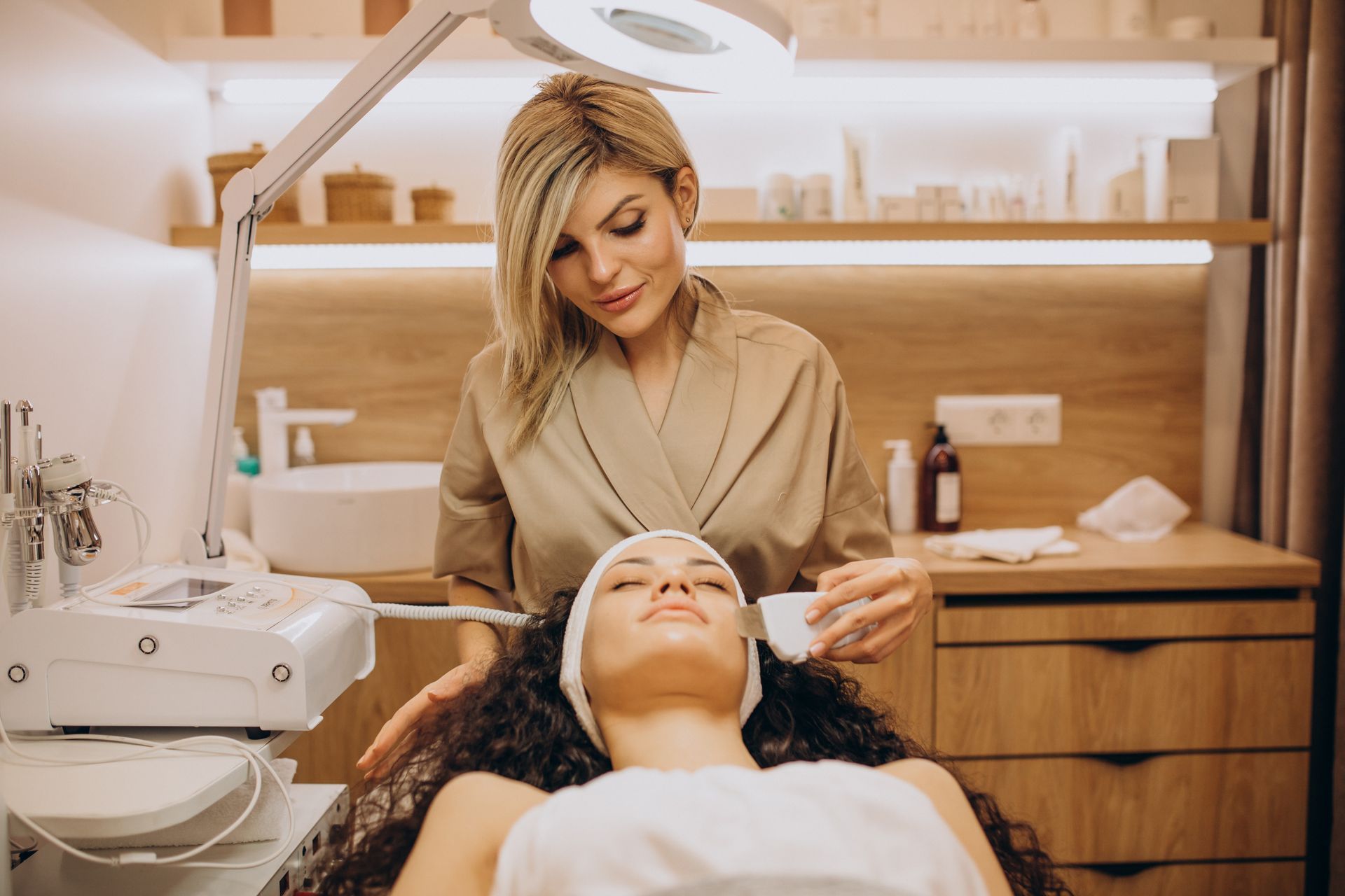 A woman is getting a facial treatment in a beauty salon.