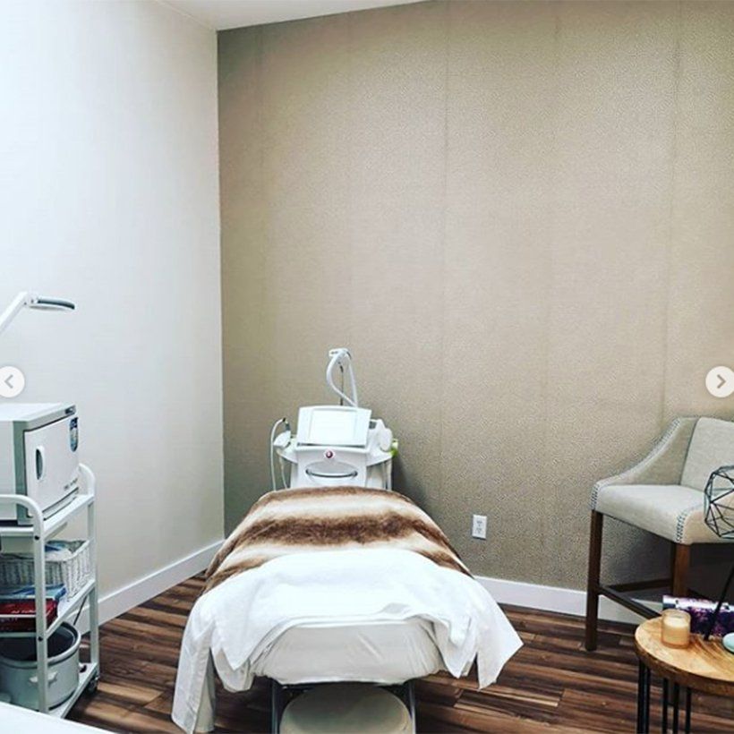 A room with a bed and a chair in it.