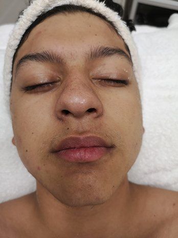 A close up of a person 's face with their eyes closed.