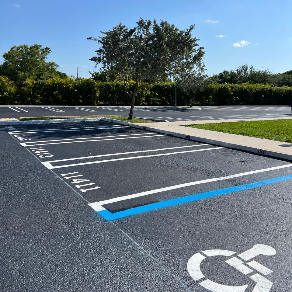 Parking lot with an accessible space marked with blue and white lines and a handicap symbol.
