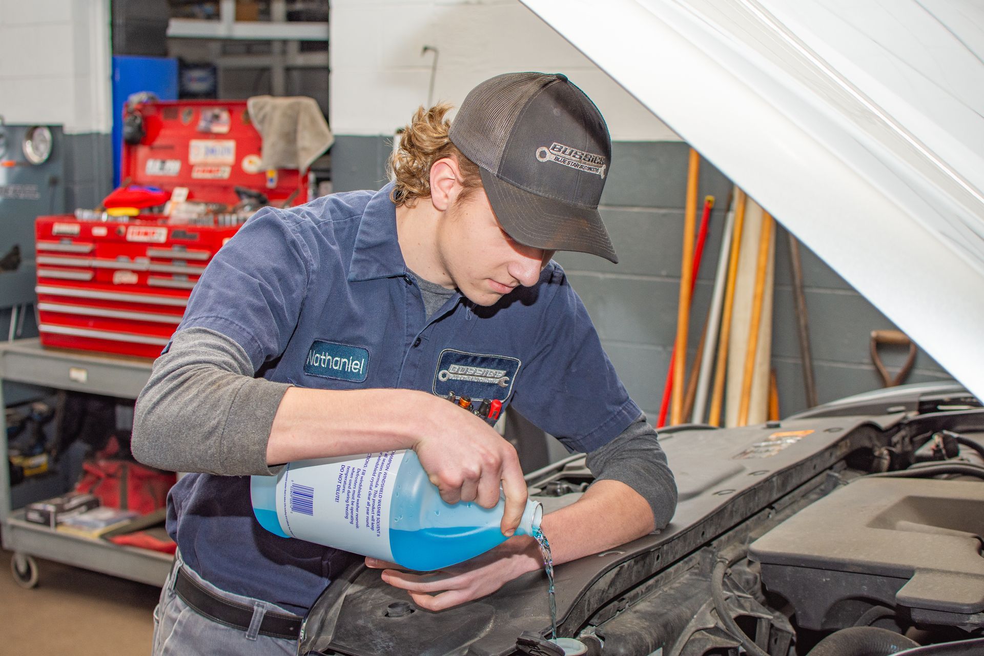 Pouring Windshield Washer Fluid | Bussies Blue Star Automotive