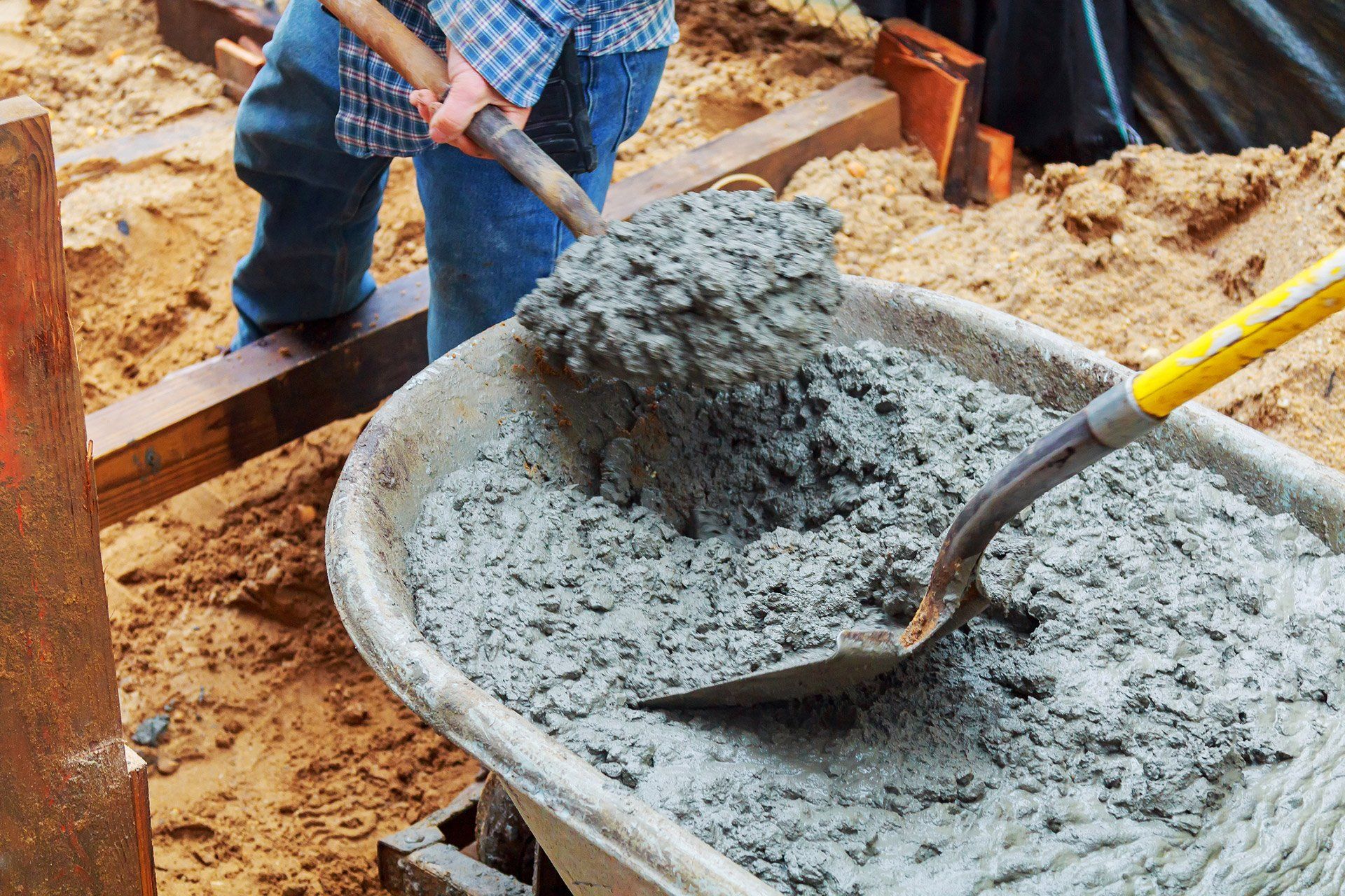 Contractor scooping concrete
