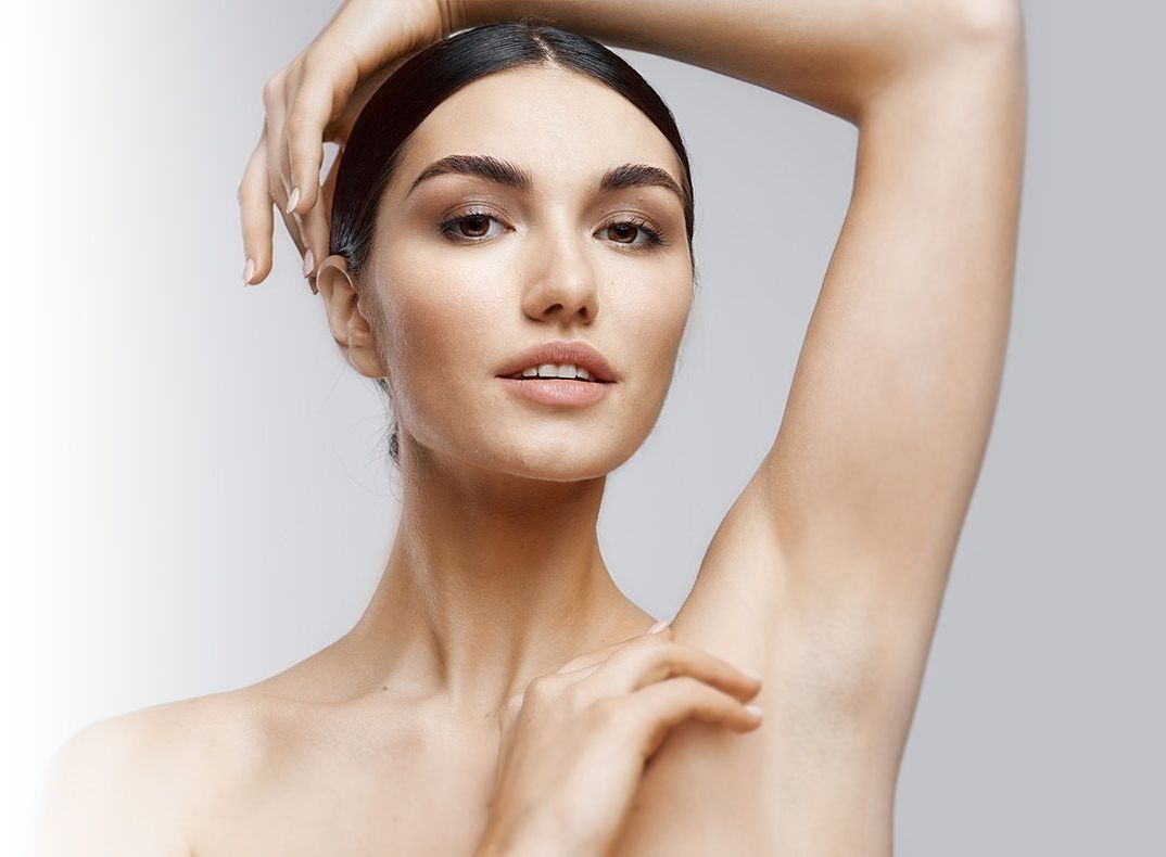 female skincare model showing bare underarm after laser hair removal