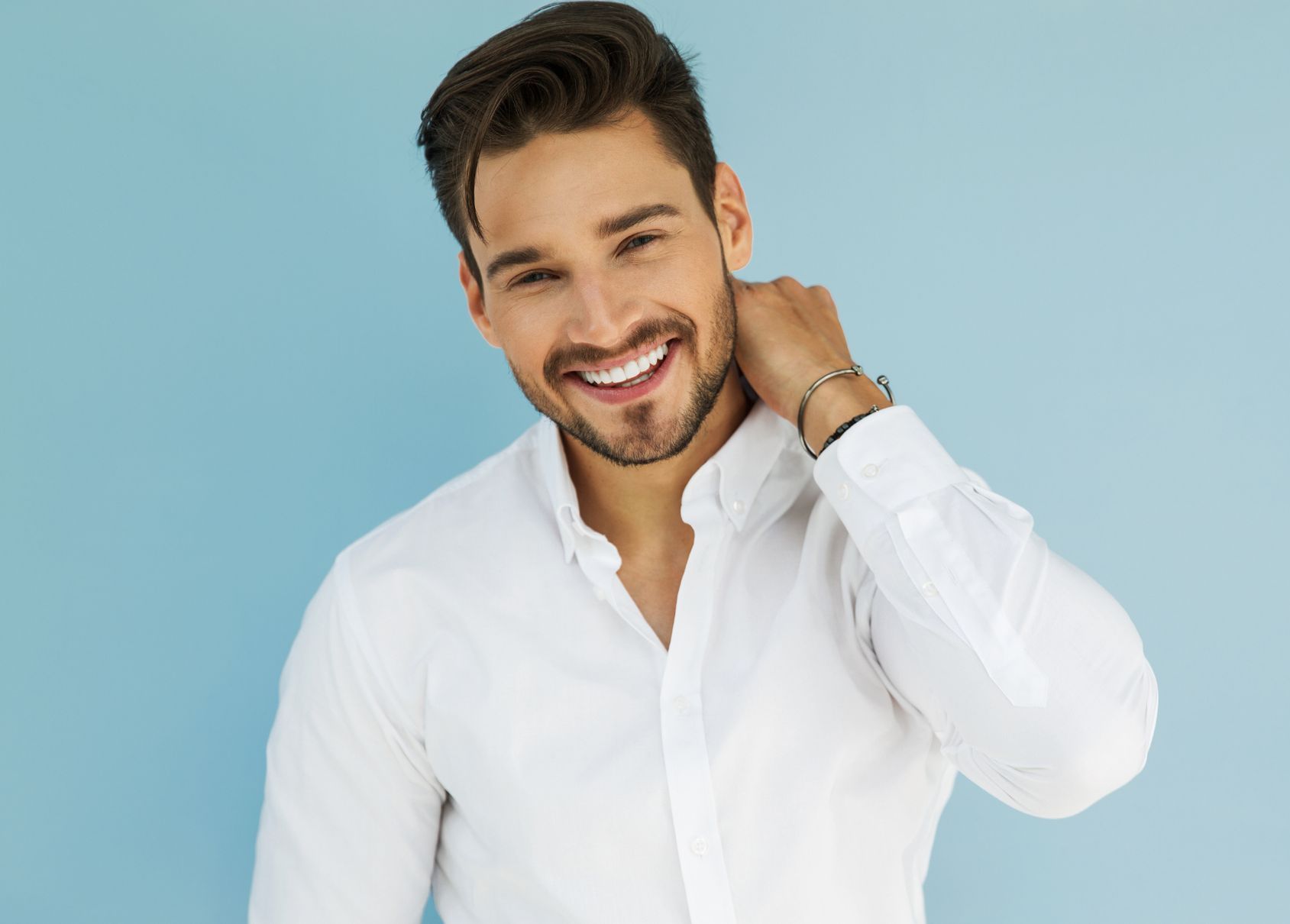male model in white button up shirt on blue background