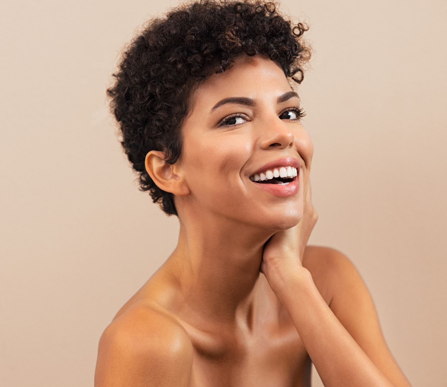 young female skincare model with short curly hair