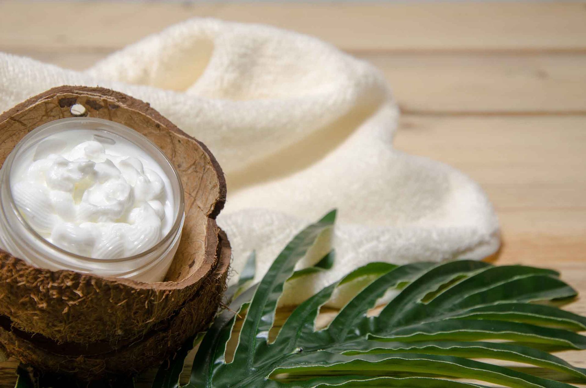 A Jar Of Coconut Cream In A Coconut Shell On A Wooden Table – Terrigal, NSW - Anjule Beauty Therapy