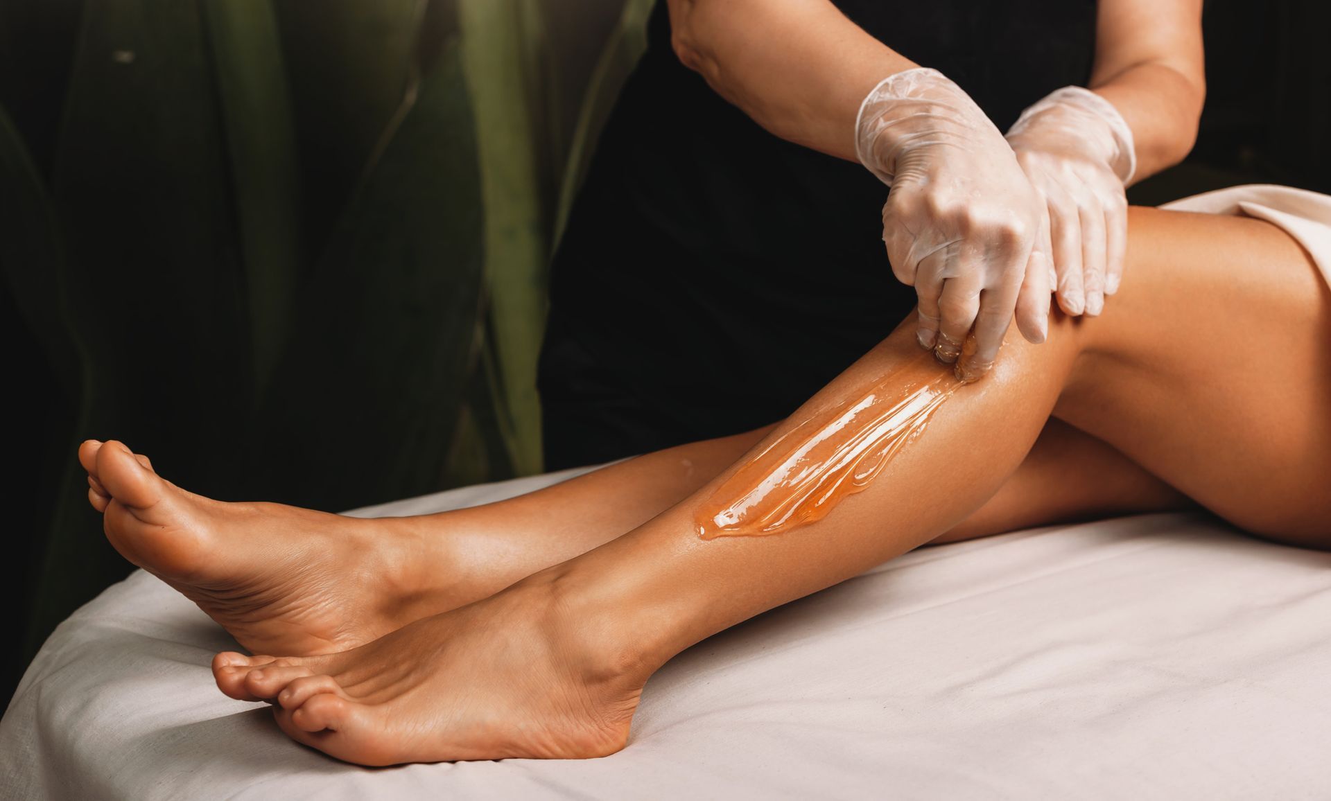A Woman Is Getting Her Legs Waxed In A Beauty Spa – Terrigal, NSW - Anjule Beauty Therapy