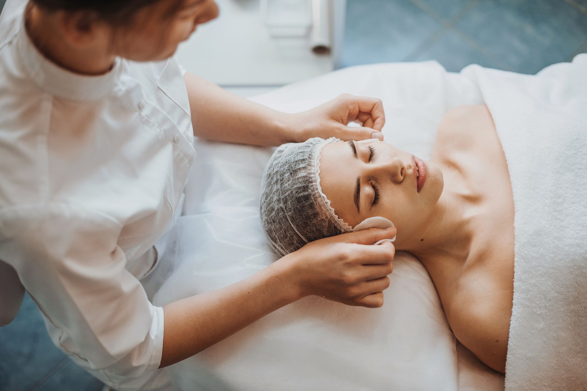 A woman is getting a facial treatment at a spa.