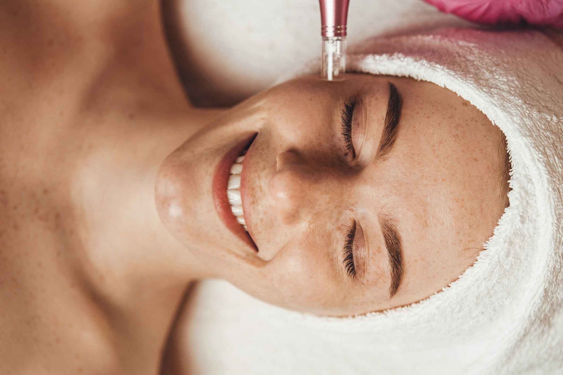 A Woman With A Towel Wrapped Around Her Head Is Getting A Facial Treatment – Terrigal, NSW - Anjule Beauty Therapy