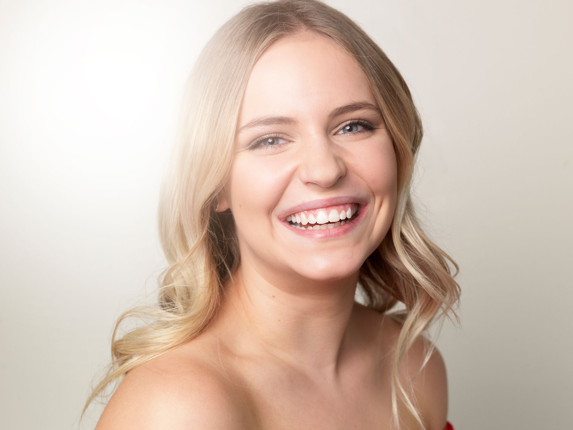 A Woman With Blonde Hair Is Smiling And Looking At The Camera – Terrigal, NSW - Anjule Beauty Therapy