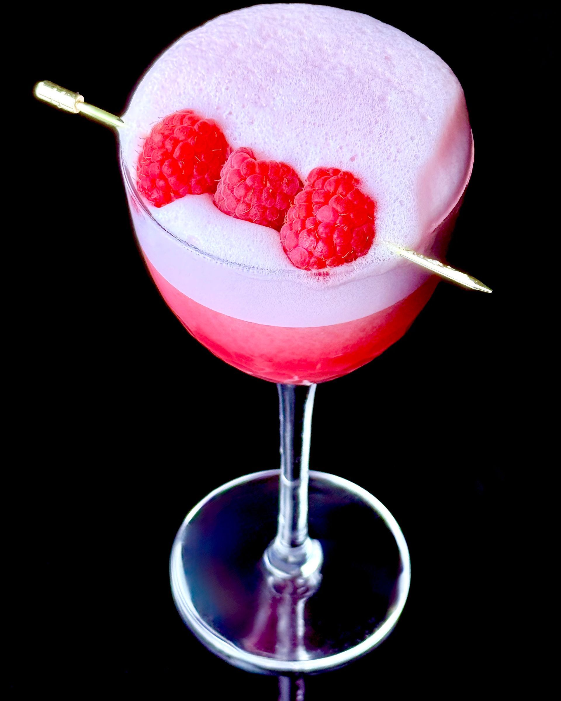 Clover Redux cocktail made with London dry gin, raspberries, egg white or cocktail foamer, and Cordial Craft