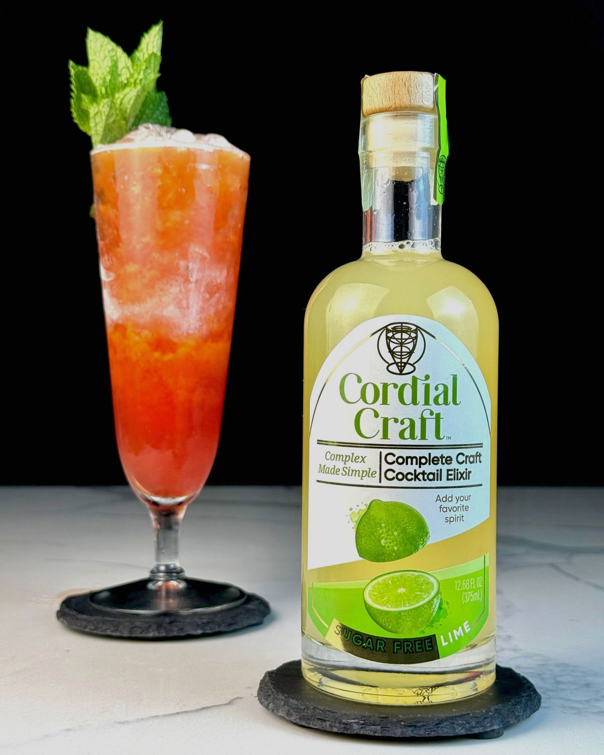 A bottle of cordial craft next to a glass