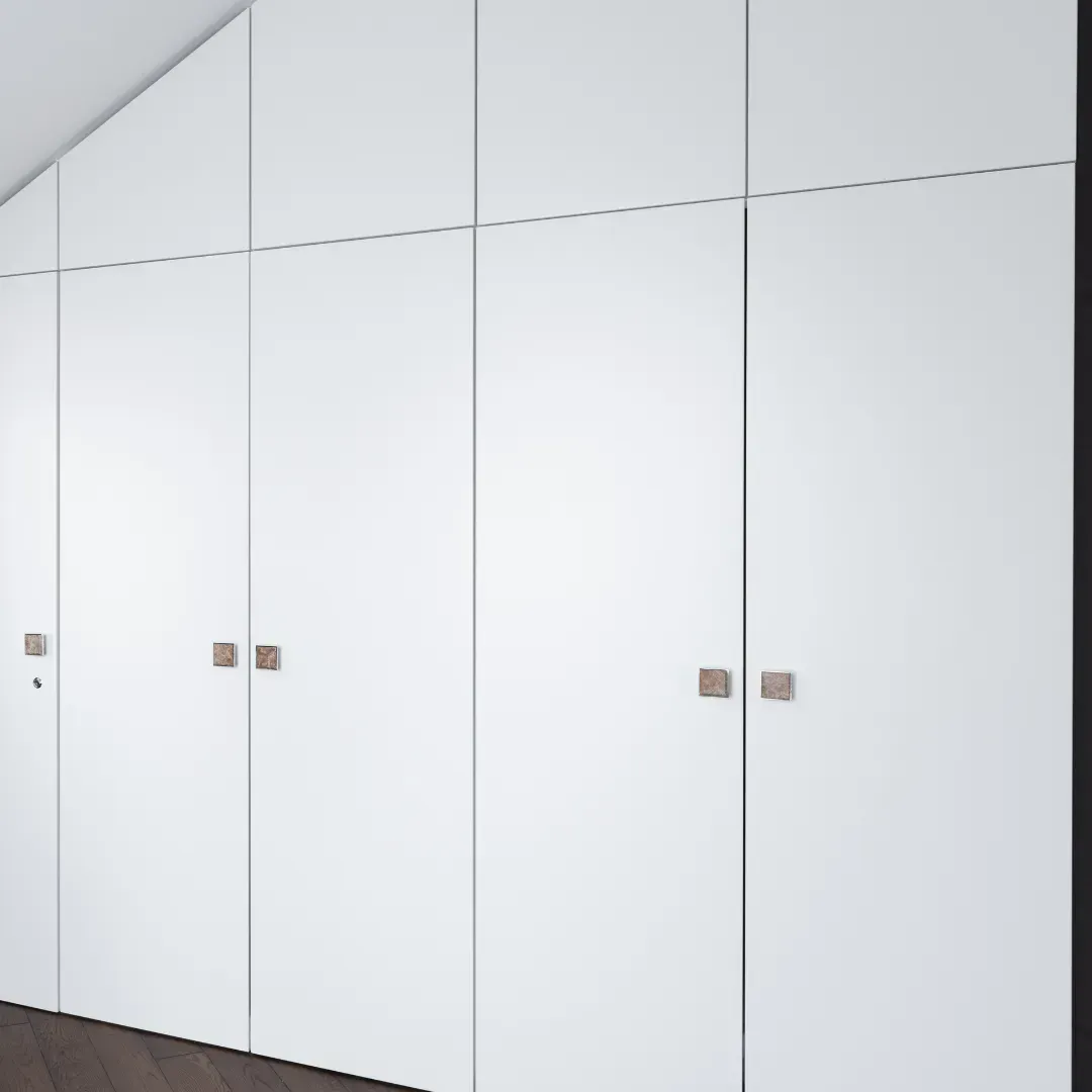 A row of white cabinets with wooden handles in a room.