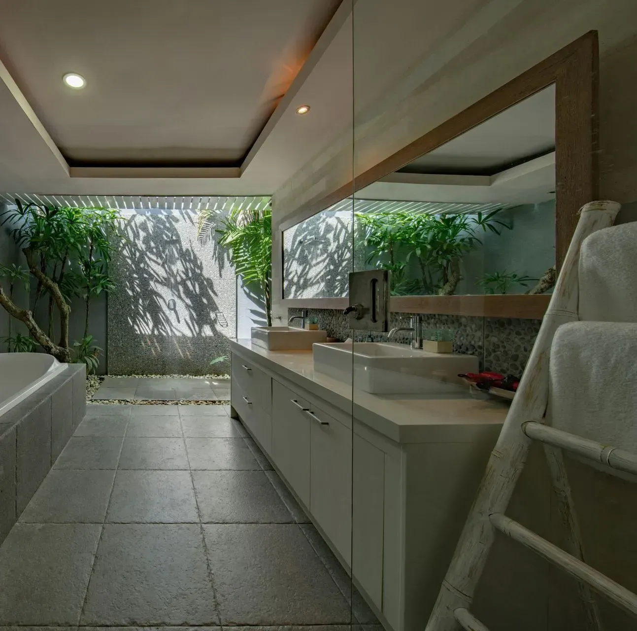 A bathroom with two sinks and a large mirror