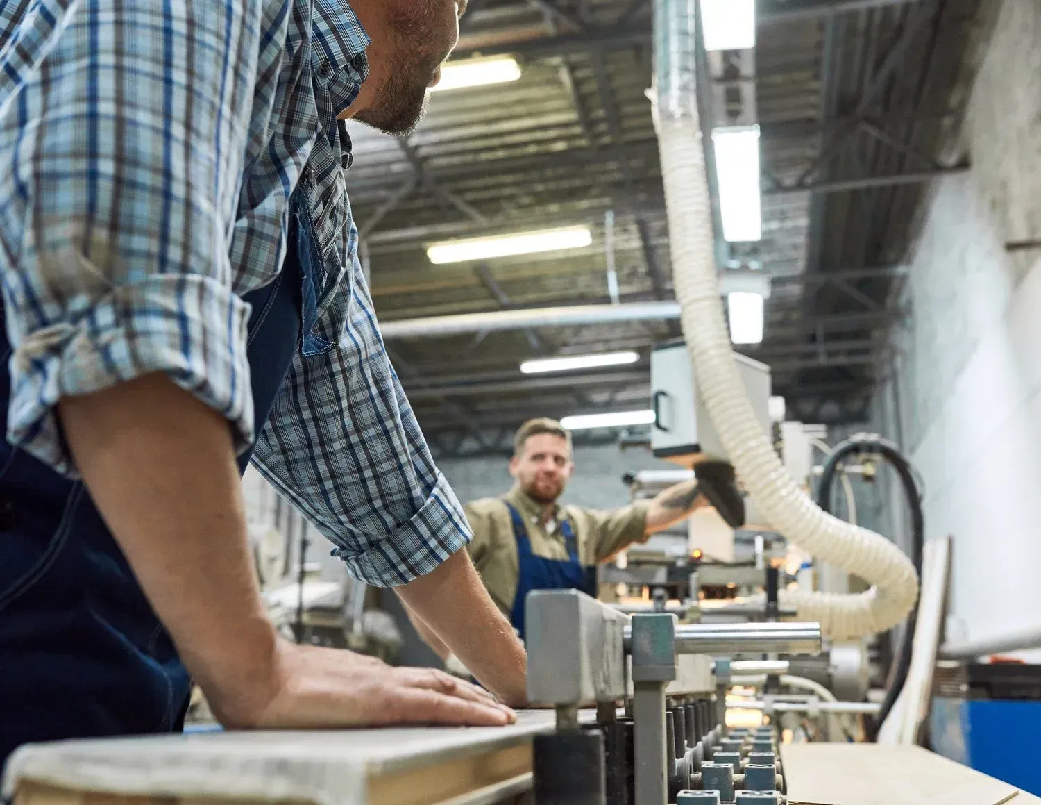 A man is working on a machine in a factory.