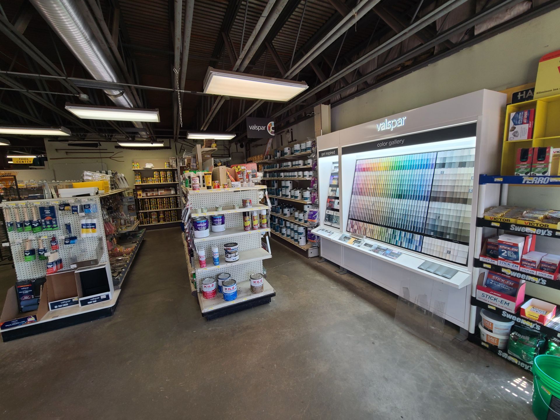 A store filled with lots of shelves and shelves of paint.
