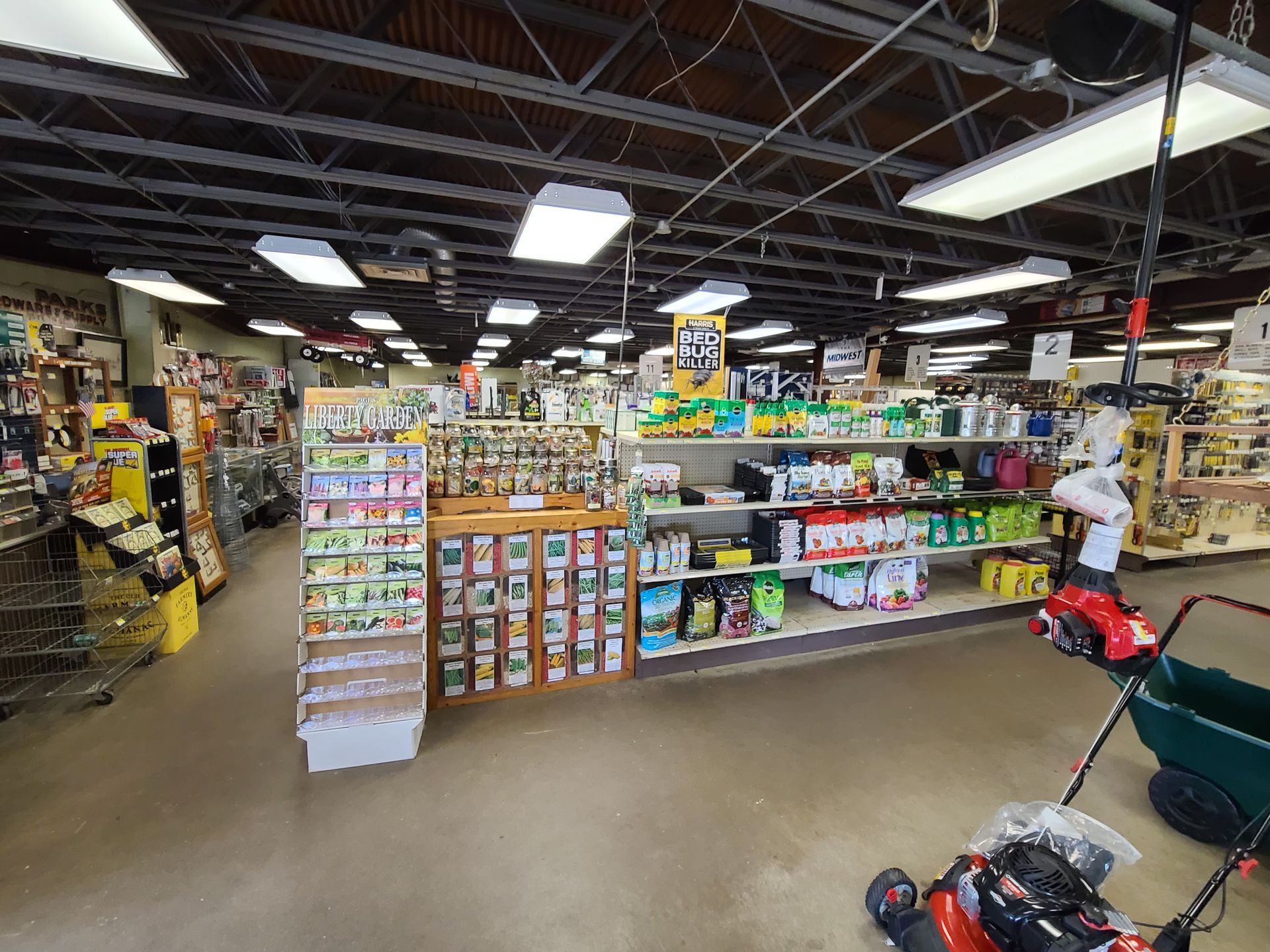 There is a lawn mower in the middle of the store.